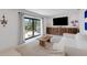 Cozy living room features stylish decor, a sliding door to the yard at 2084 Massachusetts Ne Ave, St Petersburg, FL 33703