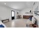 Bright bonus room with modern kitchenette, sleek table, and a comfortable sofa at 2084 Massachusetts Ne Ave, St Petersburg, FL 33703
