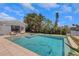 Backyard featuring a private pool with jacuzzi, lounge furniture, and lush tropical landscaping at 2084 Massachusetts Ne Ave, St Petersburg, FL 33703