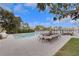 Backyard pool, patio, and dining area overlooking the waterfront and docks on a sunny day in a tropical environment at 2084 Massachusetts Ne Ave, St Petersburg, FL 33703