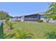 A beautifully maintained yard offering an expansive green lawn and an enclosed lanai perfect for outdoor enjoyment at 214 Lookout Dr, Apollo Beach, FL 33572