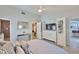 Bedroom with neutral walls, wood look floors, ceiling fan, and access to walk in closet at 214 Lookout Dr, Apollo Beach, FL 33572
