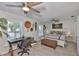 Bedroom with hardwood floors, ceiling fan, and natural lighting at 214 Lookout Dr, Apollo Beach, FL 33572
