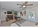 Spacious primary bedroom boasts a cozy fireplace, stylish ceiling fan, and bright natural light at 214 Lookout Dr, Apollo Beach, FL 33572