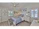 Bedroom with neutral walls, wood look floors, ceiling fan, and beach themed decor at 214 Lookout Dr, Apollo Beach, FL 33572