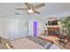 Bright primary bedroom featuring a fireplace, ceiling fan, closet, and ensuite bathroom at 214 Lookout Dr, Apollo Beach, FL 33572