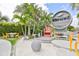 Attractive community sign, lush tropical landscaping, and inviting outdoor seating areas at 214 Lookout Dr, Apollo Beach, FL 33572