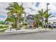 Community sign surrounded by lush landscaping and palm trees, offering a welcoming entrance at 214 Lookout Dr, Apollo Beach, FL 33572