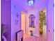 Hallway with a tiled floor, decorative mirror and lighting, and a view of an adjacent living area at 214 Lookout Dr, Apollo Beach, FL 33572