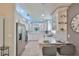 Modern kitchen featuring white cabinets, stainless steel appliances, marble countertops, and a breakfast bar at 214 Lookout Dr, Apollo Beach, FL 33572
