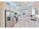 Stylish kitchen with stainless steel appliances, white cabinetry, sleek countertops, and modern lighting fixtures at 214 Lookout Dr, Apollo Beach, FL 33572