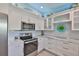 A bright kitchen features a stainless steel refrigerator, range, and microwave at 214 Lookout Dr, Apollo Beach, FL 33572