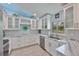 Bright kitchen featuring stainless steel appliances, white cabinets, and light wood look flooring at 214 Lookout Dr, Apollo Beach, FL 33572