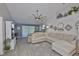 Spacious living room with plush sectional sofa, ceiling fan, and decorative wall accents at 214 Lookout Dr, Apollo Beach, FL 33572