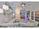 Inviting living room featuring vaulted ceilings, a cozy sectional, and stylish decor with a view to the front door at 214 Lookout Dr, Apollo Beach, FL 33572
