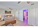 Comfortable main bedroom featuring a ceiling fan, ample closet space, and an adjacent hallway leading to other rooms at 214 Lookout Dr, Apollo Beach, FL 33572