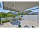 Backyard patio offers an outdoor dining table with an umbrella and seating, perfect for outdoor gatherings and relaxation at 214 Lookout Dr, Apollo Beach, FL 33572