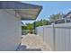 Outdoor patio featuring a brick surface, white fencing, covered awning, and garden views at 214 Lookout Dr, Apollo Beach, FL 33572