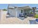 Side yard patio area with comfortable seating and awning, creating a cozy outdoor space at 214 Lookout Dr, Apollo Beach, FL 33572
