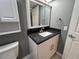 Bathroom vanity with dark granite counters, updated fixtures and hardware at 2295 Mexican Way # 41, Clearwater, FL 33763
