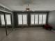 This bedroom offers tile floors, plantation shutters, a ceiling fan, and neutral decor at 2295 Mexican Way # 41, Clearwater, FL 33763