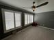 Bedroom with light gray paint, tile floors, plantation shutters, and modern ceiling fan at 2295 Mexican Way # 41, Clearwater, FL 33763