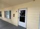 The entrance to unit 41 features impact windows and a screen door at 2295 Mexican Way # 41, Clearwater, FL 33763