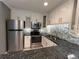 Updated kitchen featuring granite counters, stainless steel appliances, and stylish backsplash at 2295 Mexican Way # 41, Clearwater, FL 33763