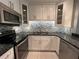 Updated kitchen featuring granite counters, stainless steel appliances, and ample storage at 2295 Mexican Way # 41, Clearwater, FL 33763