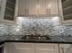 Updated kitchen featuring tiled backsplash, stainless steel sink, and modern cabinetry at 2295 Mexican Way # 41, Clearwater, FL 33763