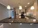 Updated kitchen features white cabinetry, stainless steel appliances, and dark granite countertops at 2295 Mexican Way # 41, Clearwater, FL 33763