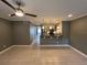 Open-concept living area with ceiling fan and bar access to the modern kitchen at 2295 Mexican Way # 41, Clearwater, FL 33763