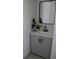 Modern bathroom features a gray vanity, a sleek mirror, and stylish fixtures at 2551 12Th St, Englewood, FL 34224