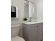 A clean bathroom features a gray vanity, modern mirror, and decorative accents at 2551 12Th St, Englewood, FL 34224