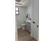 A bright bathroom features a gray vanity, toilet, and wood-look flooring at 2551 12Th St, Englewood, FL 34224
