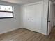 Bright bedroom with wood floors, closet, and natural light from the window at 2551 12Th St, Englewood, FL 34224