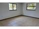 Bedroom with ceramic tiles, white walls, and large windows for natural light at 2551 12Th St, Englewood, FL 34224
