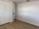 A bedroom with wood floors, white walls, closet, and a modern door at 2551 12Th St, Englewood, FL 34224
