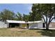 Charming single-story home with a white metal roof and black rock exterior at 2551 12Th St, Englewood, FL 34224