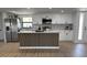 Bright kitchen featuring stainless steel appliances, white cabinets, granite countertops and a waterfall island at 2551 12Th St, Englewood, FL 34224