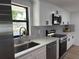 Kitchen features stainless steel appliances, granite countertops, undermount sink and white cabinets at 2551 12Th St, Englewood, FL 34224