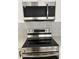 A modern kitchen features stainless steel appliances, a microwave and a glass tile backsplash at 2551 12Th St, Englewood, FL 34224