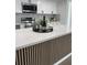 Kitchen featuring a waterfall island, stainless steel appliances, white cabinets, and granite countertops at 2551 12Th St, Englewood, FL 34224