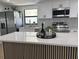 Kitchen featuring a waterfall island, stainless steel appliances, white cabinets, and granite countertops at 2551 12Th St, Englewood, FL 34224