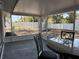 Patio with table and chairs looking out to fenced backyard at 2551 12Th St, Englewood, FL 34224