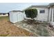 Cozy backyard featuring a shed and patio area, perfect for relaxation and storage at 3035 Coldwell Dr, Holiday, FL 34691