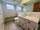 Bathroom featuring decorative fixtures, a bathtub, and a vanity at 3035 Coldwell Dr, Holiday, FL 34691
