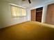 A bedroom with a large closet and window dressed with lightweight curtains at 3035 Coldwell Dr, Holiday, FL 34691
