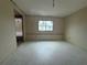 An unfinished bedroom with a window overlooking the front yard at 3035 Coldwell Dr, Holiday, FL 34691