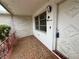 Inviting front porch featuring patterned tile flooring and a secure front door at 3035 Coldwell Dr, Holiday, FL 34691